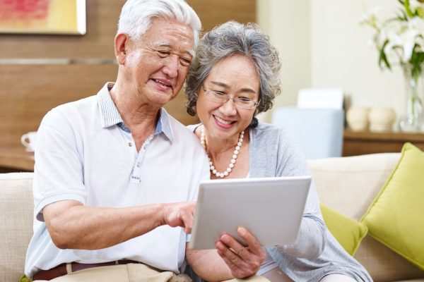 Older couple reading a tablet